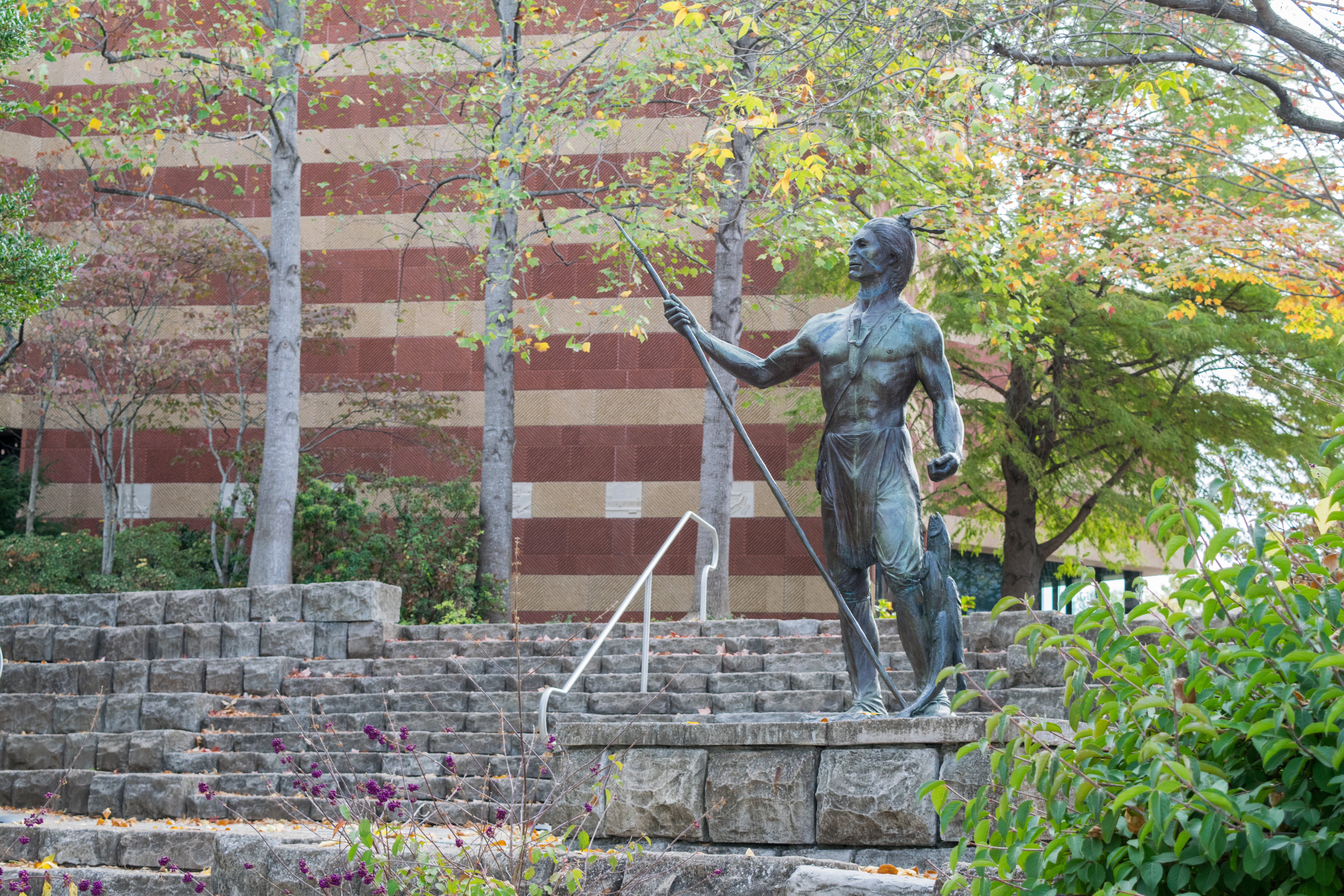 Statue of Cherokee at river bank with fish - Walk Cha Tour in Chattanooga
