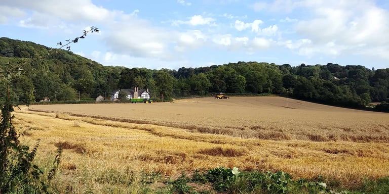 Wythall Estate and Lower Wythall across a field of hay in Ross-on-Wye England