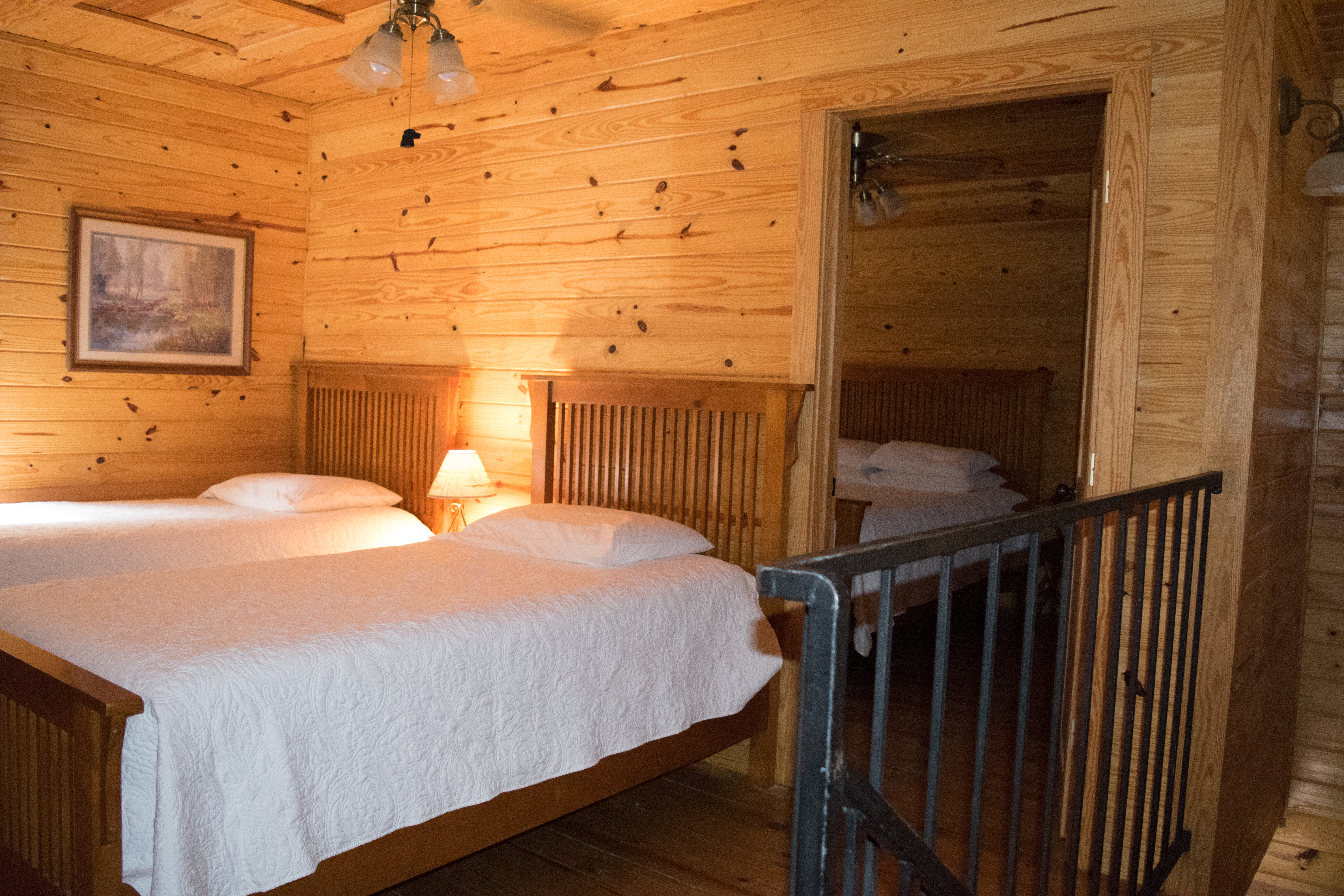 Interior view of upper loft and adjacent master bedroom at Cabins of Horseshoe Hills Ranch