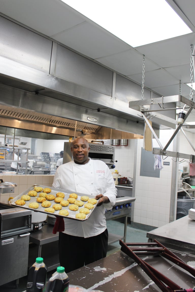 Chef Desmond Marshall with crabcakes at Sandals Barbados